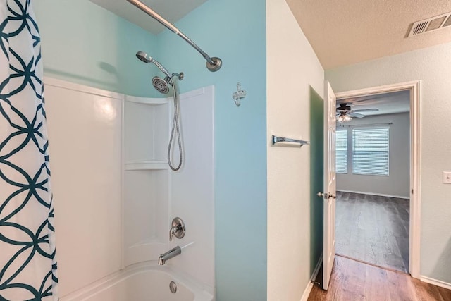 9504 Southwick Dr, Austin, TX 78724 - bathroom featuring shower / bath combination with curtain, wood finished floors, and a ceiling fan