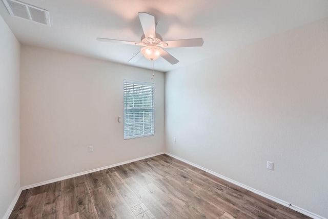 9504 Southwick Dr, Austin, TX 78724 - empty room with wood finished floors, a ceiling fan, and baseboards