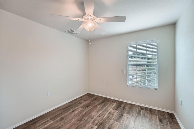 9504 Southwick Dr, Austin, TX 78724 - empty room with wood finished floors, a ceiling fan, and baseboards