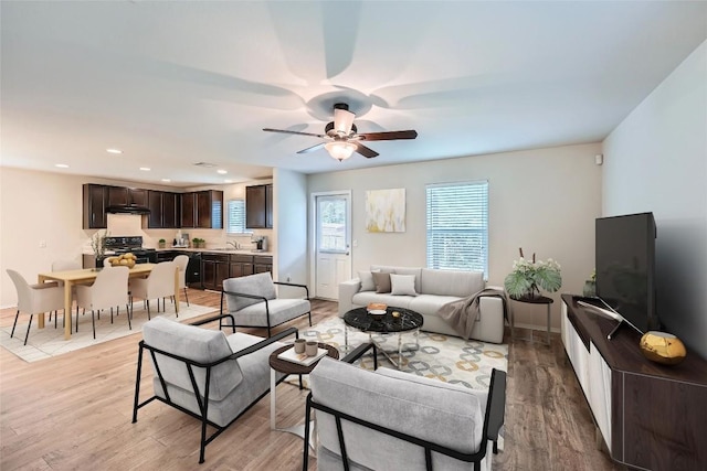 9504 Southwick Dr, Austin, TX 78724 - living room featuring light wood-style flooring, ceiling fan, recessed lighting, and baseboards