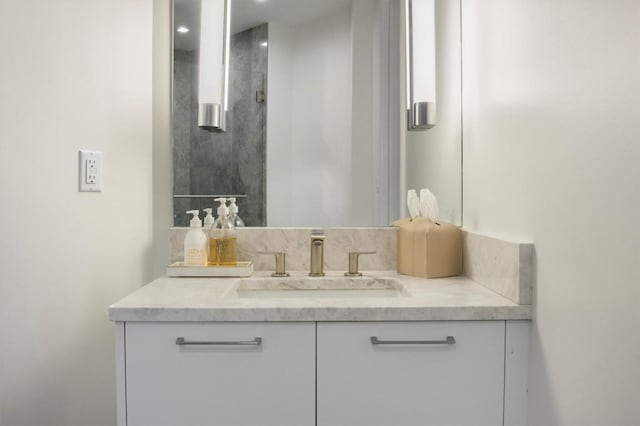 bathroom with a shower and vanity