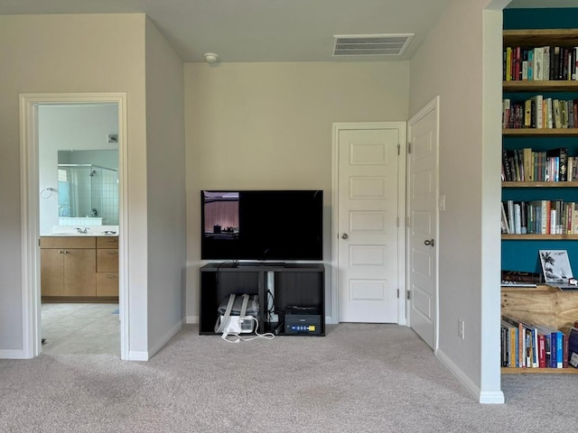interior space featuring baseboards, carpet, and visible vents