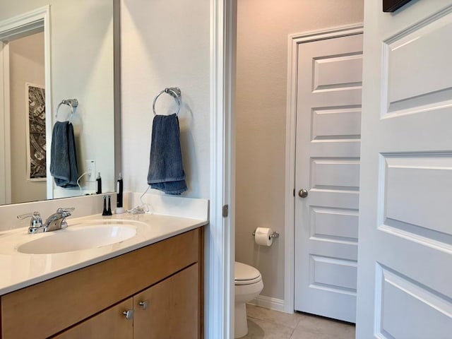 bathroom with vanity, tile patterned flooring, and toilet