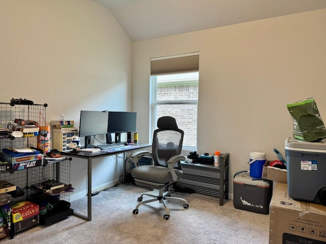carpeted office space with baseboards and lofted ceiling