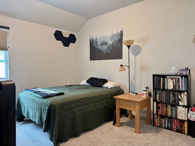 bedroom featuring carpet floors and lofted ceiling