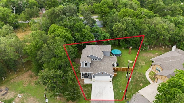birds eye view of property with a wooded view