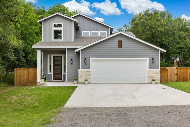 view of front facade featuring board and batten siding, fence, a shingled roof, and a front yard