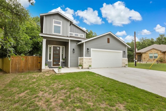 view of front of property featuring board and batten siding, a garage, fence, a front lawn, and concrete driveway