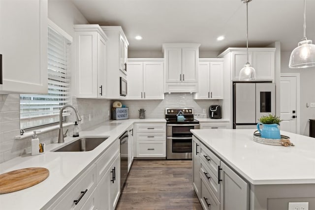 kitchen featuring a sink, appliances with stainless steel finishes, custom exhaust hood, and recessed lighting