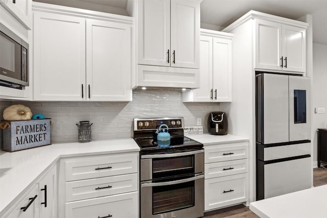 kitchen featuring light countertops, appliances with stainless steel finishes, under cabinet range hood, and white cabinetry
