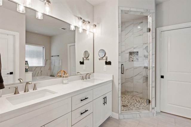 bathroom featuring a sink, a marble finish shower, and visible vents