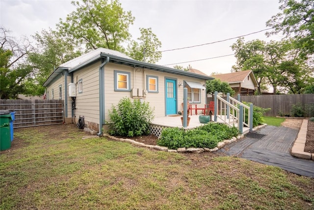 913 Fowzer St, Taylor, TX 76574 - exterior space featuring a lawn, a wooden deck, and fence