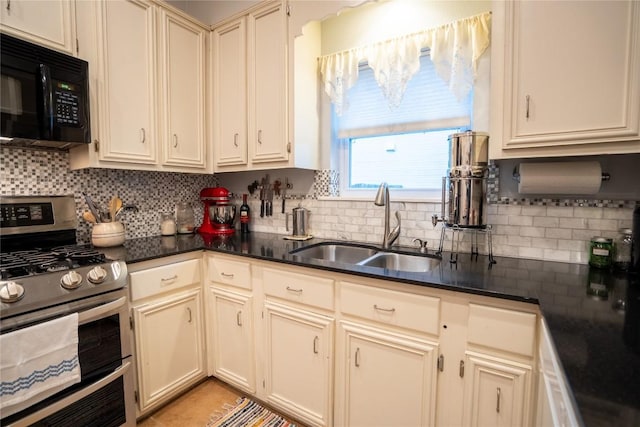 913 Fowzer St, Taylor, TX 76574 - kitchen featuring range with two ovens, black microwave, dark countertops, tasteful backsplash, and a sink