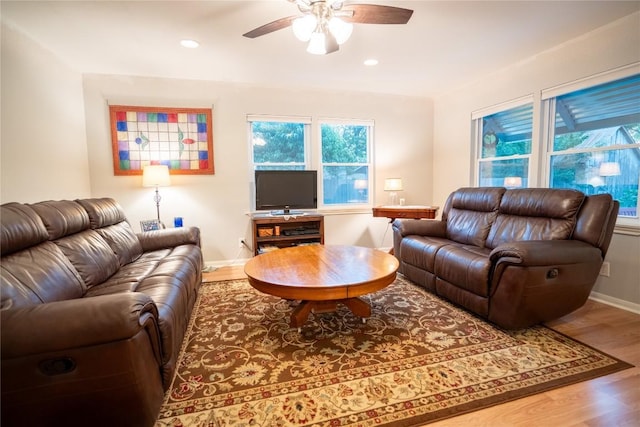 913 Fowzer St, Taylor, TX 76574 - living area with baseboards, ceiling fan, wood finished floors, and a wealth of natural light