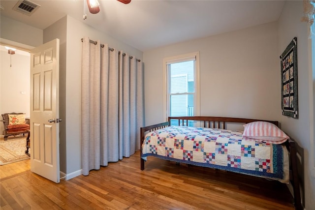 913 Fowzer St, Taylor, TX 76574 - bedroom featuring baseboards, a ceiling fan, wood finished floors, and visible vents