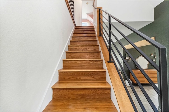 stairway featuring wood finished floors