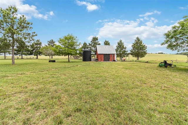 view of yard with a barn and an outbuilding
