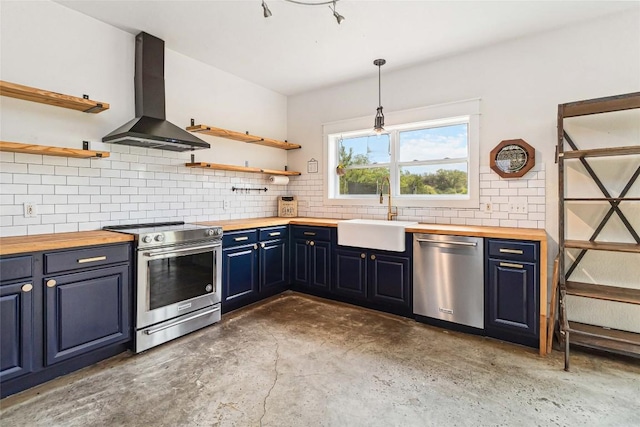 kitchen with wall chimney range hood, open shelves, a sink, butcher block counters, and stainless steel appliances