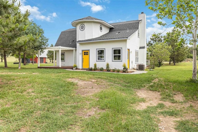 modern inspired farmhouse featuring a shingled roof, a front lawn, stucco siding, and a chimney