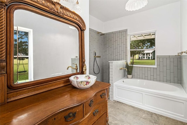 full bath featuring vanity, a tile shower, and a garden tub