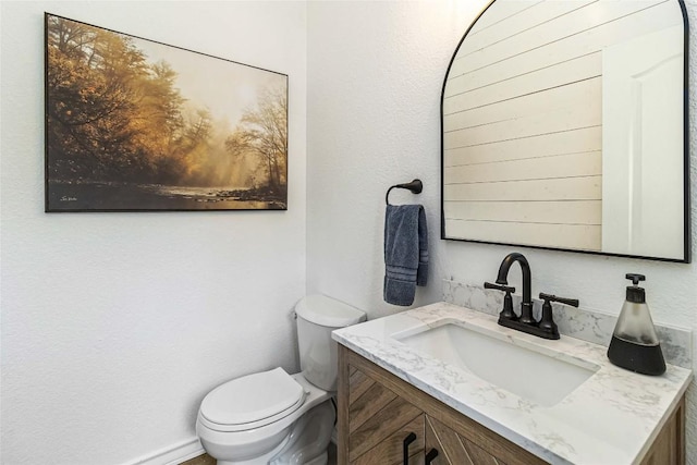 half bath with vanity and toilet
