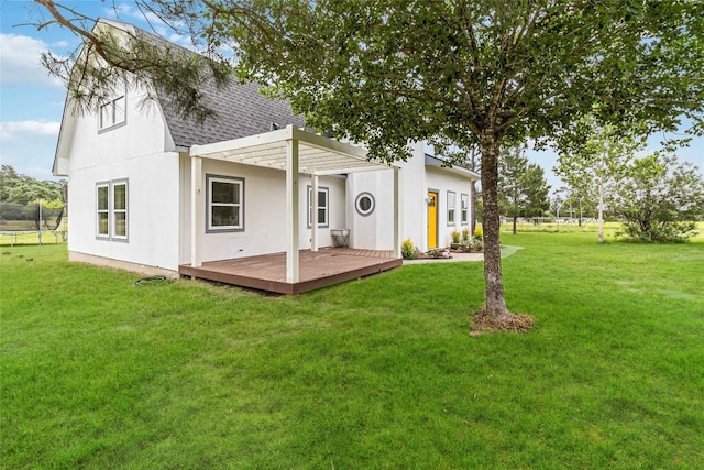 245 Country Ln, Mcdade, TX 78650 - back of house with roof with shingles, a deck, stucco siding, and a lawn