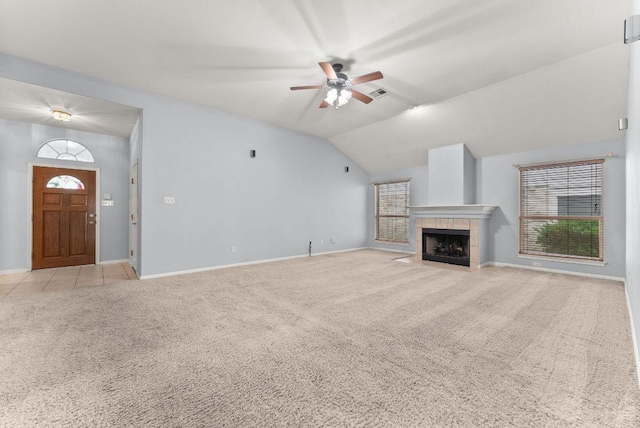 1564 Lorson Loop, Round Rock, TX 78665 - unfurnished living room with light colored carpet, a ceiling fan, healthy amount of natural light, lofted ceiling, and a fireplace