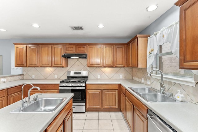 1564 Lorson Loop, Round Rock, TX 78665 - kitchen with stainless steel appliances, under cabinet range hood, light countertops, brown cabinets, and recessed lighting