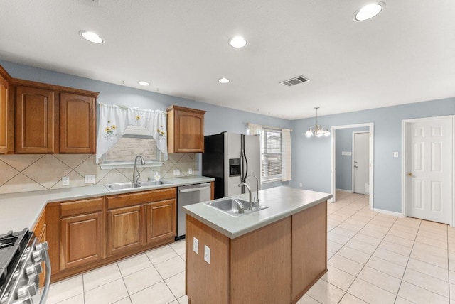 1564 Lorson Loop, Round Rock, TX 78665 - kitchen with stainless steel appliances, a chandelier, brown cabinetry, decorative backsplash, and recessed lighting