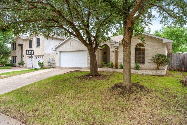 1564 Lorson Loop, Round Rock, TX 78665 - view of front of house featuring concrete driveway, an attached garage, and stone siding