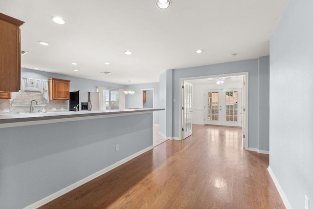 1564 Lorson Loop, Round Rock, TX 78665 - kitchen with stainless steel refrigerator with ice dispenser, french doors, light wood-type flooring, recessed lighting, and brown cabinetry