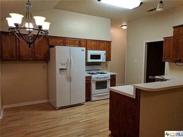 1502 Stratford Dr, Killeen, TX 76549 - kitchen featuring white appliances, light wood finished floors, pendant lighting, a chandelier, and light countertops
