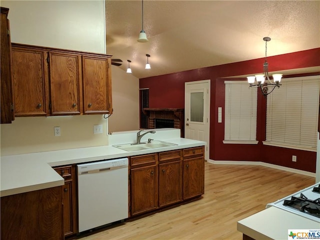 1502 Stratford Dr, Killeen, TX 76549 - kitchen featuring white dishwasher, a chandelier, light wood finished floors, pendant lighting, and light countertops