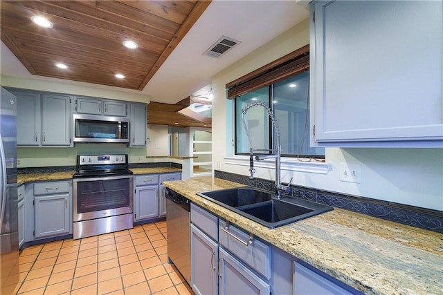 kitchen featuring recessed lighting, wood ceiling, a sink, appliances with stainless steel finishes, and light tile patterned floors