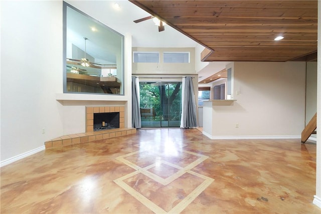 unfurnished living room with baseboards, concrete flooring, a ceiling fan, and wood ceiling