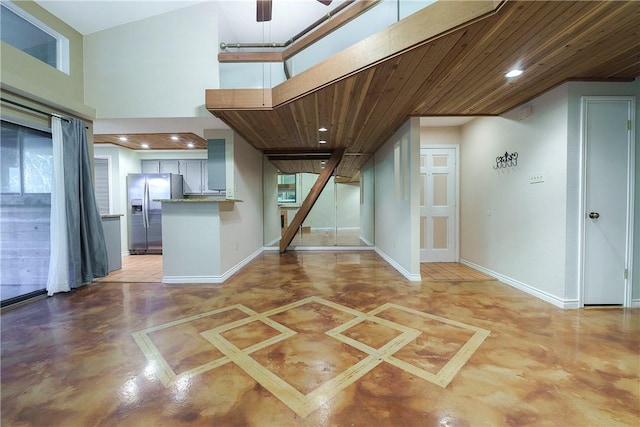 interior space featuring baseboards, recessed lighting, wood ceiling, and a ceiling fan