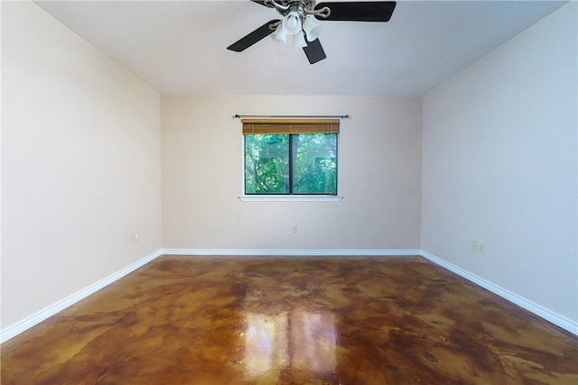 unfurnished room with ceiling fan, baseboards, and finished concrete flooring