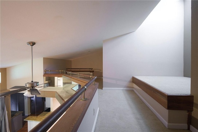 corridor with baseboards, carpet floors, and an upstairs landing