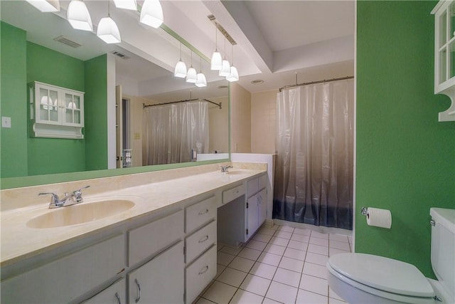 bathroom featuring a sink, toilet, and visible vents