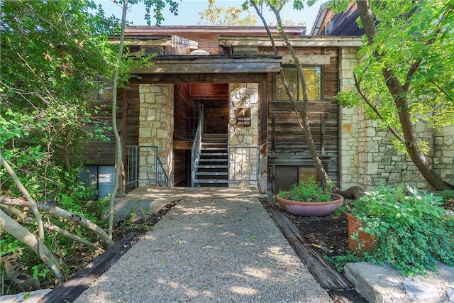 property entrance with stone siding