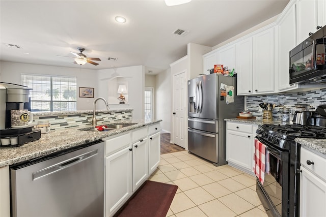 1900 Scofield Ridge Parkway Unit 1903, Austin, TX 78727 - kitchen with a ceiling fan, decorative backsplash, a sink, and black appliances