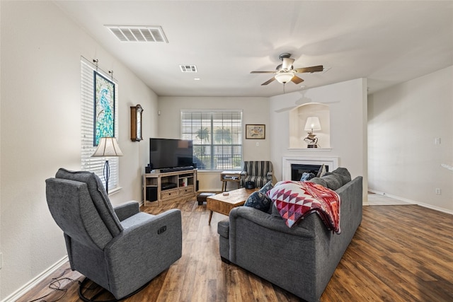 1900 Scofield Ridge Parkway Unit 1903, Austin, TX 78727 - living area with baseboards, a fireplace, a ceiling fan, and visible vents