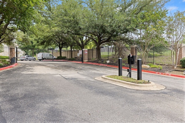 1900 Scofield Ridge Parkway Unit 1903, Austin, TX 78727 - view of road with a gated entry, a gate, and curbs