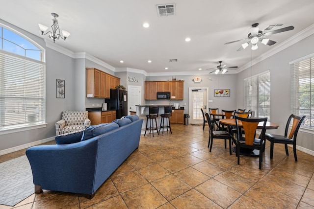 1900 Scofield Ridge Parkway Unit 1903, Austin, TX 78727 - living area with ceiling fan with notable chandelier, recessed lighting, baseboards, visible vents, and ornamental molding