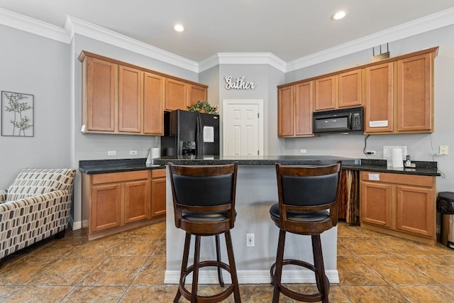 1900 Scofield Ridge Parkway Unit 1903, Austin, TX 78727 - kitchen featuring a breakfast bar, brown cabinetry, a kitchen island, ornamental molding, and black appliances
