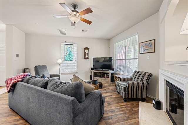 1900 Scofield Ridge Parkway Unit 1903, Austin, TX 78727 - living room featuring a glass covered fireplace, ceiling fan, dark wood-style floors, and visible vents