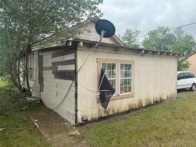 view of side of home featuring a yard