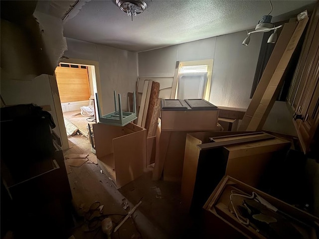 miscellaneous room with a textured ceiling