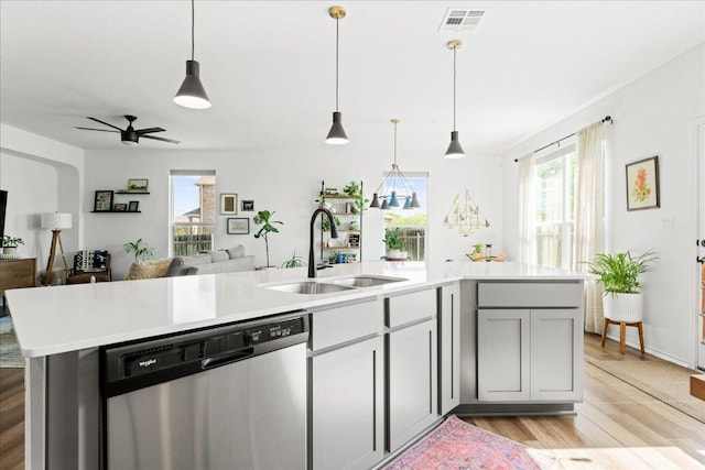210 Maroon Ln, Kyle, TX 78640 - kitchen with stainless steel dishwasher, open floor plan, healthy amount of natural light, and light countertops