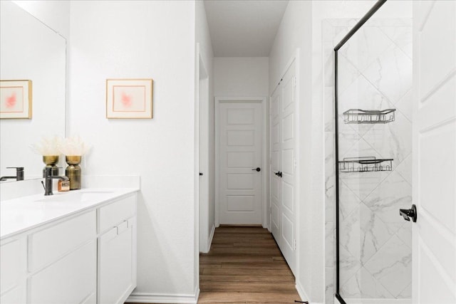 210 Maroon Ln, Kyle, TX 78640 - full bath featuring vanity, a marble finish shower, and wood finished floors